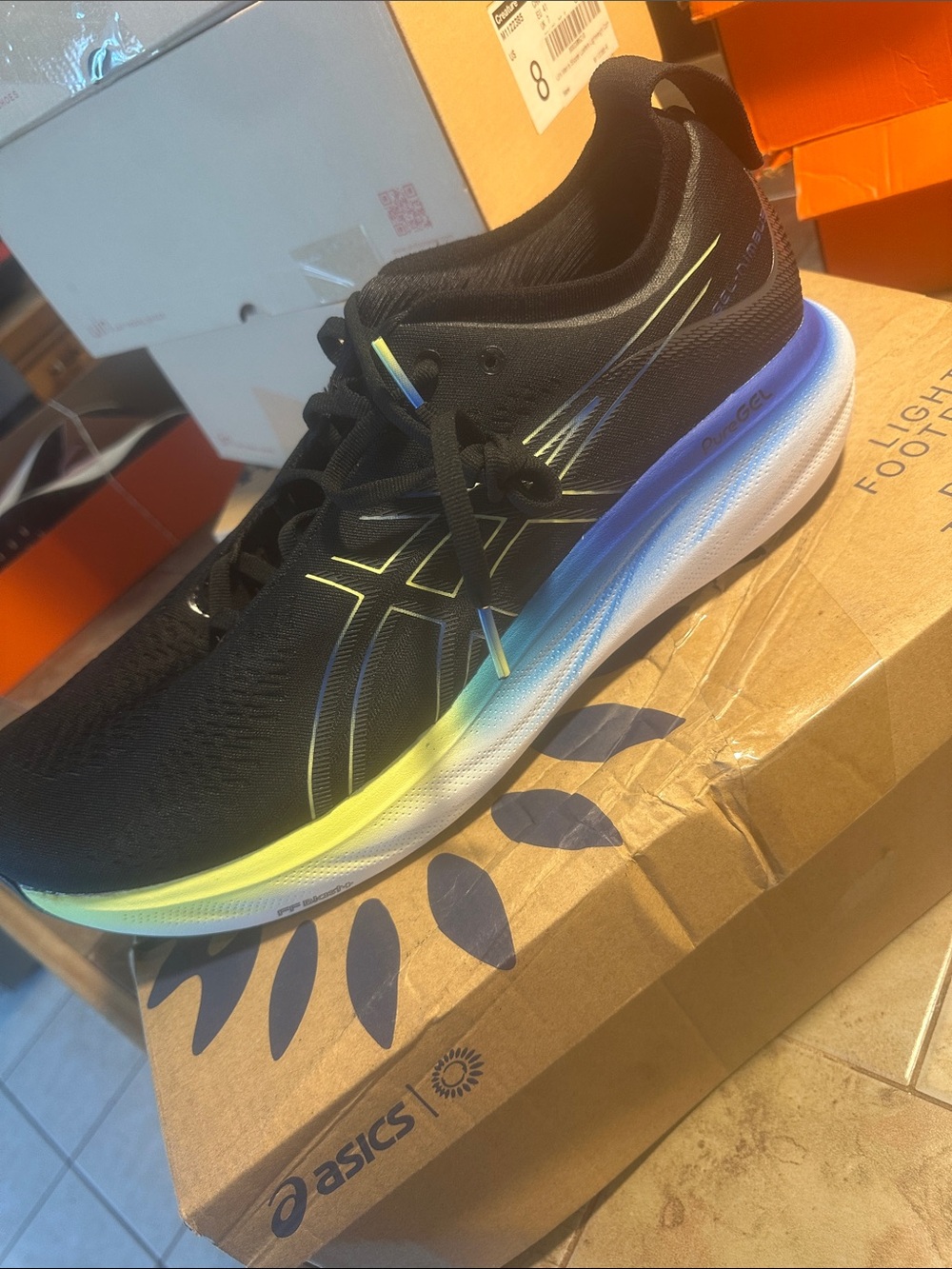 Asics Black Running Shoe with Yellow and Blue Gradient Midsole Accent